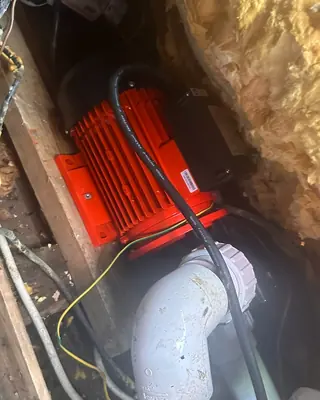 Red hot tub pump motor inside a cabinet