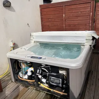 Hot tub with the cabinet open and the control pack showing