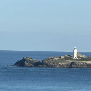 Lighthouse on a rocky island off the Cornish coast